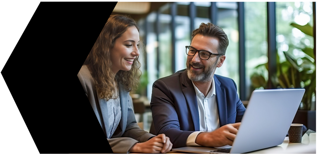 Employees working together at laptop