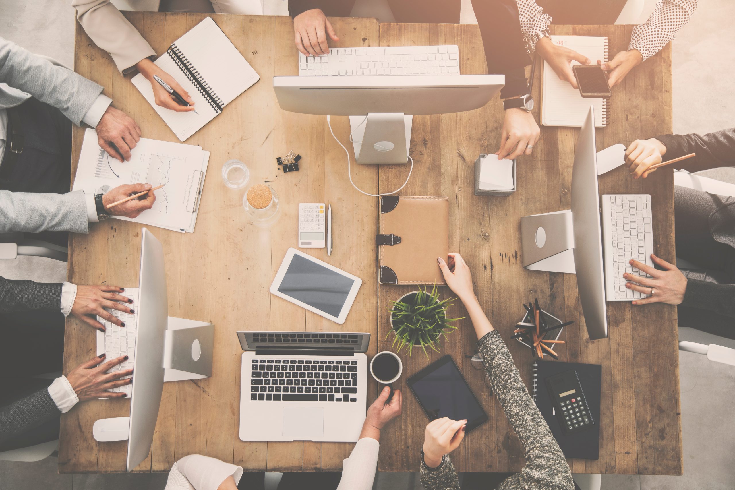 Employees working together at laptop