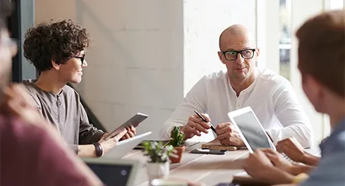 Employees talking at a meeting table