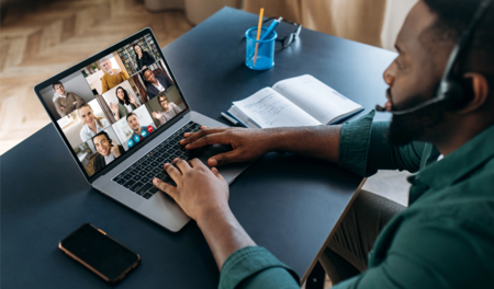 Man on laptop with headset