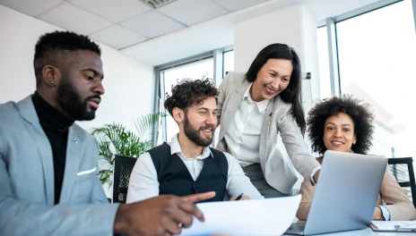 Employees working together at laptop